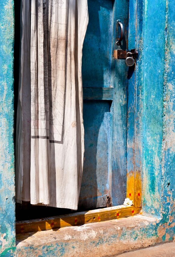 Oude blue door with curtain
